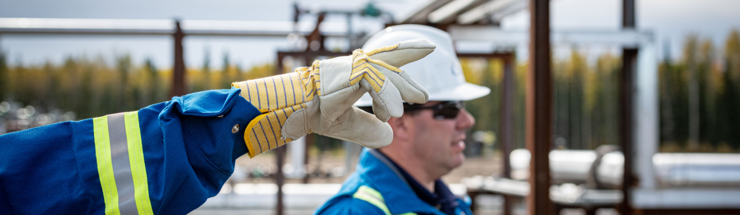 Two men in hard hats, one is pointing